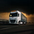 Wei�er LKW mit leuchtenden, runden LED-Scheinwerfern X-Spider Ninja auf dem Dach, f�hrt auf einer Stra�e bei D�mmerung.